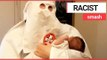 Dad pictured holding his baby dressed in Ku Klux Klan robes | SWNS TV