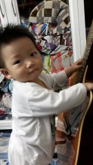 Baby plays guitar