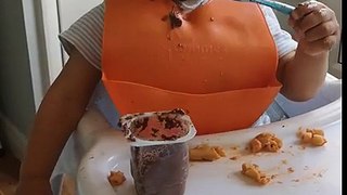 Little Boy Making A Mess Of His Food