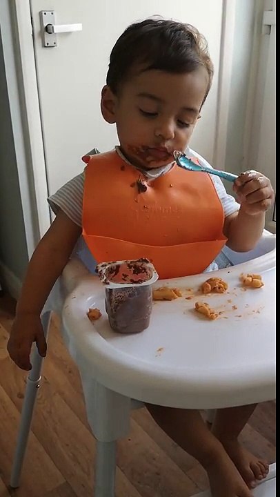 Little Boy Making A Mess Of His Food