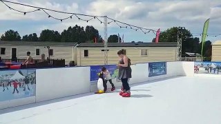 Woman falls over on the ice rink while iceskating