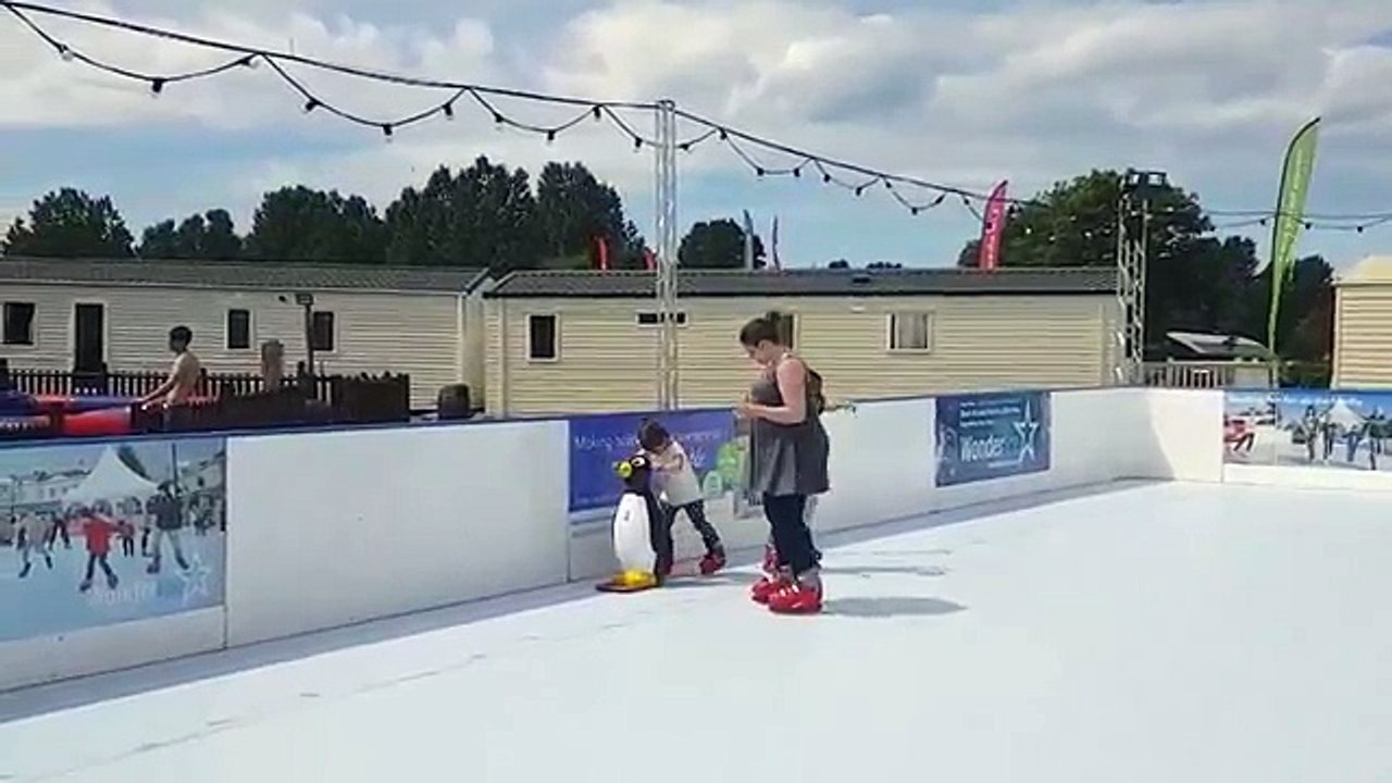 Woman falls over on the ice rink while iceskating