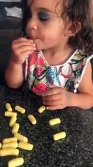 Little girl wearing make-up eats Wotsits whilst she's sleeping