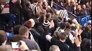football fans cheer on lad as he slides down the stair railing and then gets a round of applause