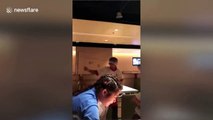 Waiter pulls single-strand noodle onto waitress’s hair