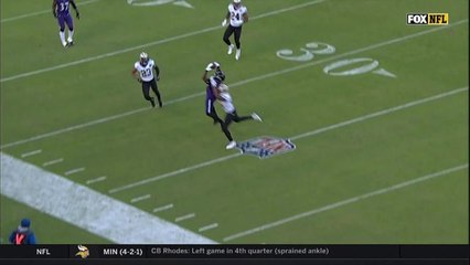 Crabtree somehow makes sideline catch after Flacco scramble