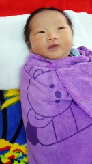 Newborn baby opens eyes to see the world