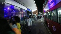 Excited London fans watch rapper Jaden Smith perform through shop window