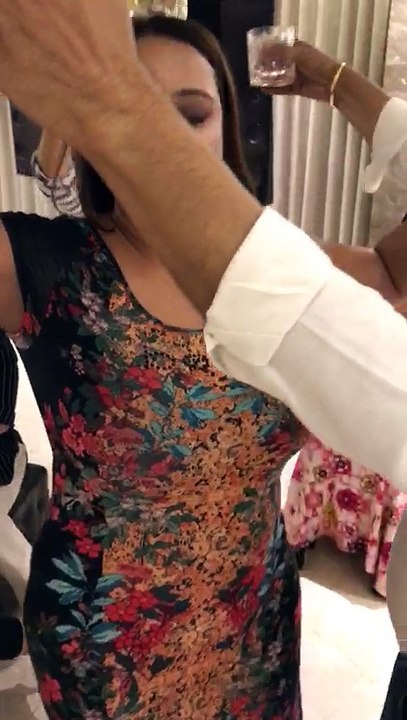 woman dancing put beer glass on her head