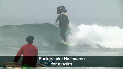 Surfers hit Newport Beach waves in Halloween costumes