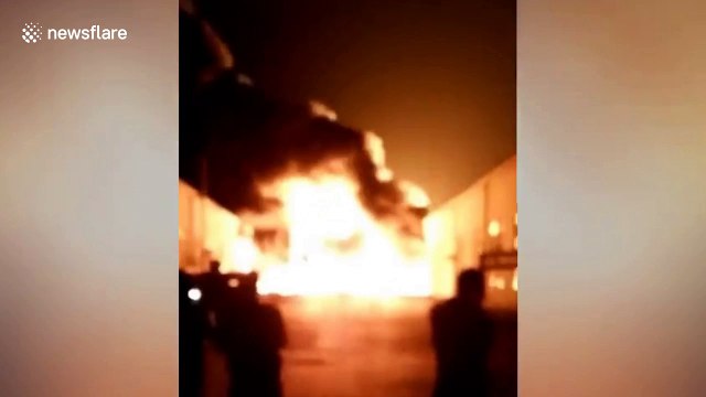 Dramatic footage shows roaring flames and massive smoke flumes as warehouse catches fire in northeast Chinese city
