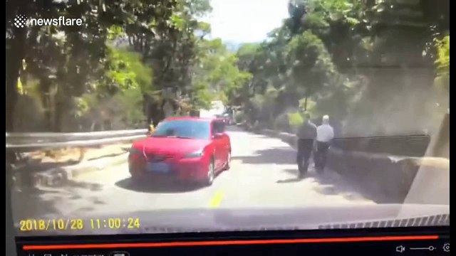 Car loses control on slope and slides down before flipping over