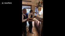 Business as usual: Venice restaurant staff wade through flood water to serve customers