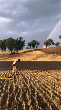 Happy Farmer Splashing in Rain Puddles