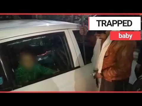 Baby being rescued from car after left for two hours | SWNS TV