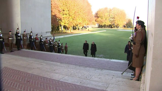 Theresa May lays a wreath at a war memorial in France