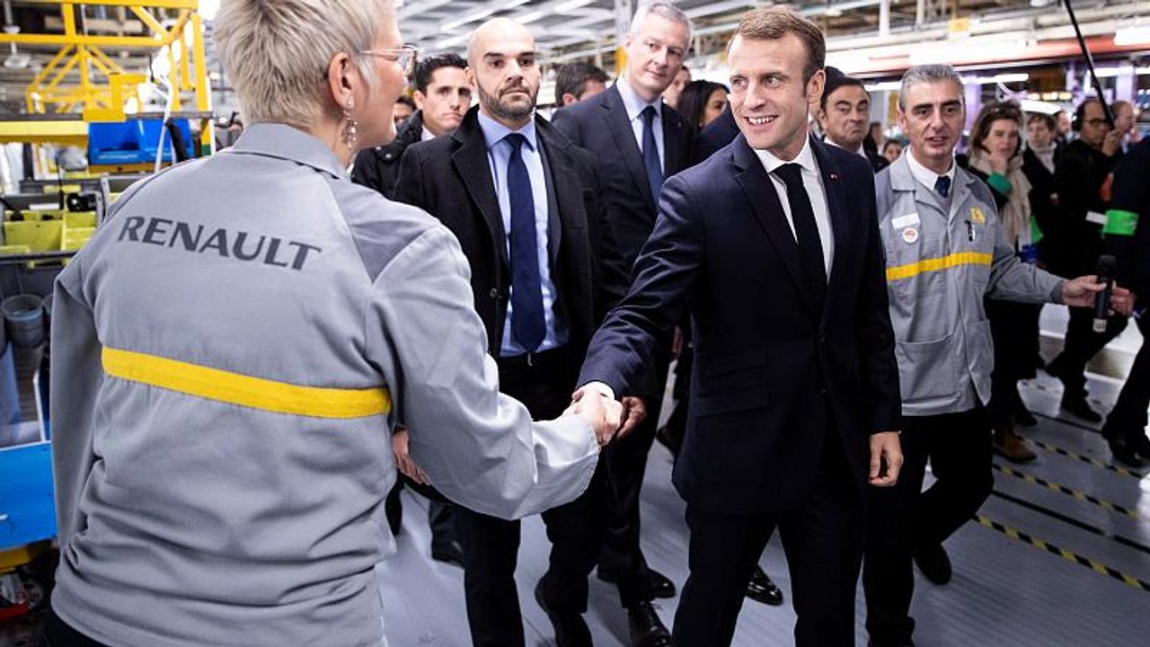 Macron defies hecklers