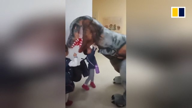 To keep promise, Chinese father picks up his daughter in a dinosaur costume