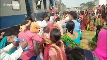 Train passengers fight to get into incredibly crowded train in India