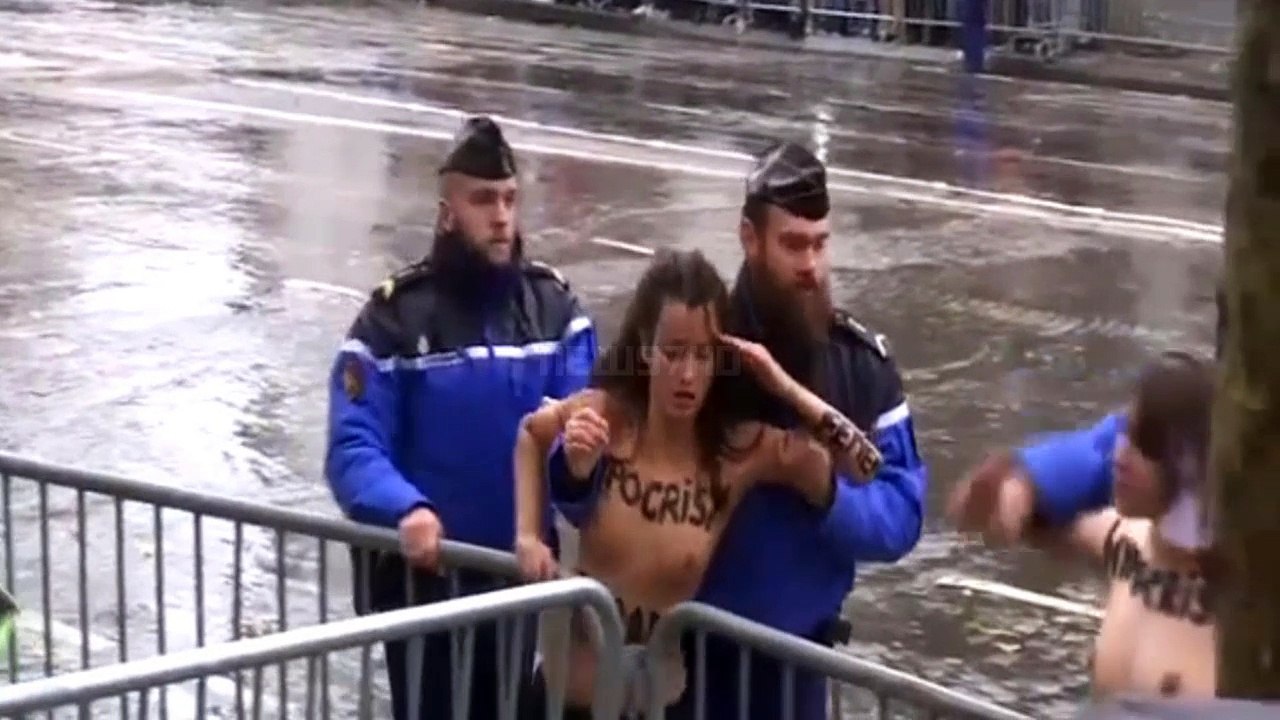 Topless protester leaps at Donald Trump's motorcade in Paris
