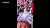 Young fan freaks out when LeBron hands his arm sleeve to him