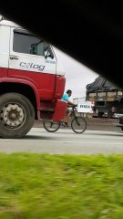 Bicycle Catches a Ride Behind Truck