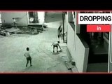 Boy miraculously survives 40ft plunge from rooftop after landing on friend | SWNS TV