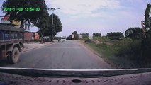 Man Crashes Motorcycle and Narrowly Escapes Moving Truck