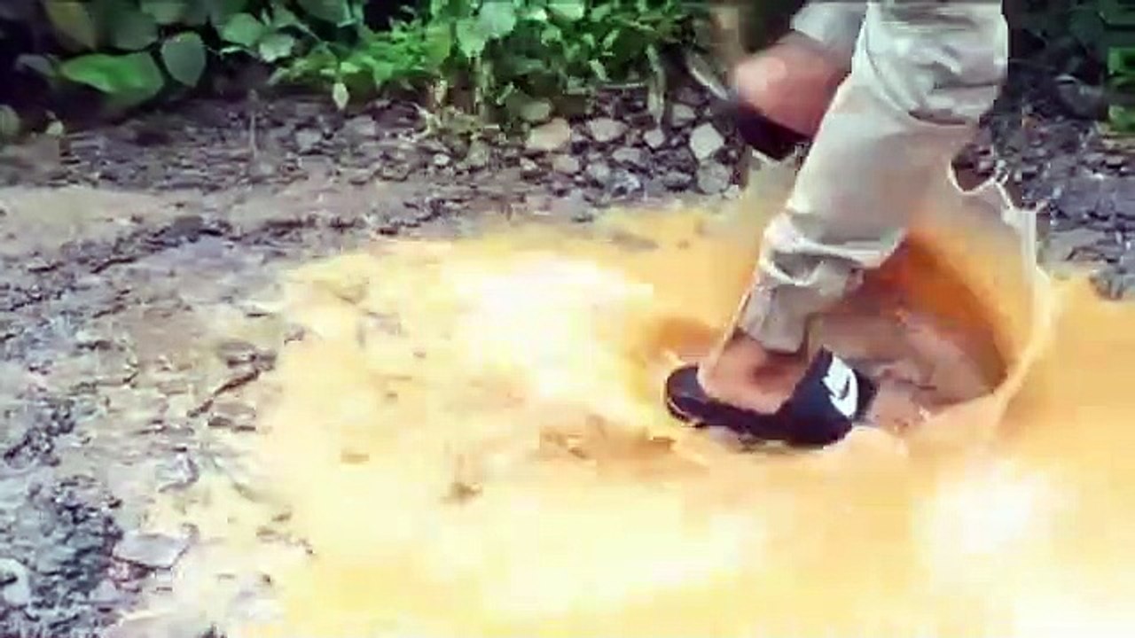 2 funny indians doing some funny dance outside car in street