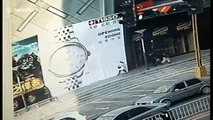 Giant billboard blows over onto pedestrians