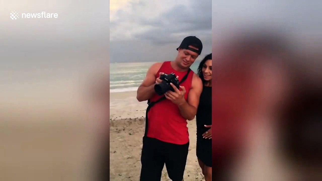 Boyfriend makes surprise beachside proposal under a rainbow
