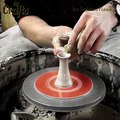 Making a clay pottery tea pot on the wheel