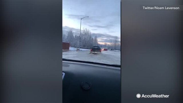 Powerful earthquake causes water pipe burst, flood spills onto road