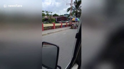 Tender moment schoolchildren help struggling elderly ice cream seller push cart up hill
