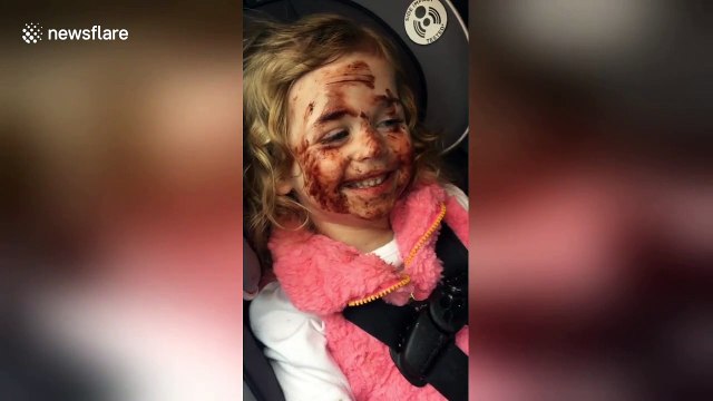 Naughty 3-year-old paints her face with chocolate while waiting in the car