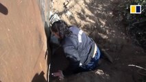 Migrants cross into US by crawling under border fence