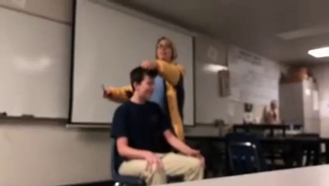 Teacher arrested after she cuts off student's hair while singing