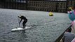 Guy Dressed as Unicorn Cheers Paddle Boarder Finishing Race