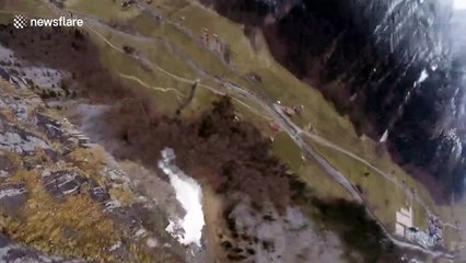 Man dives into the abyss wing-suiting through foggy Swiss valley