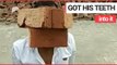 Moment man shows off his bizarre talent for lifting bricks with his TEETH | SWNS TV