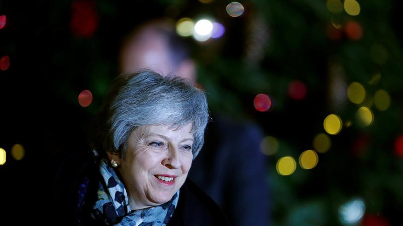 May heads for Brussels after surviving rebels' challenge