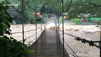 Flash floods batter suspension bridge in southern Thailand
