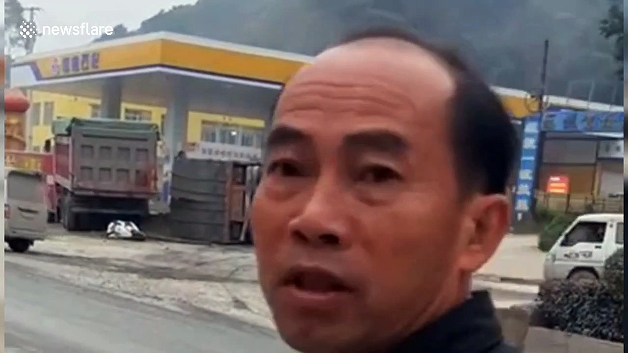 Men on scooter narrowly escape being buried by lorry tipping over on road