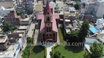 Church in India- aerial journey over a crowded urban village in India