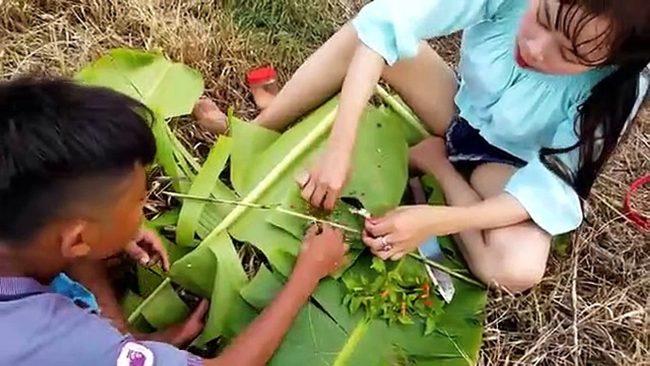 Survival skill girl fishing in waterfall with young boy then she cooking for eating  -  Wilderness Cooking