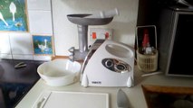 Meat mincer setup with chopping board and knife ready for use