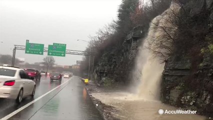Heavy rain creates a rapid waterfall on Interstate 40