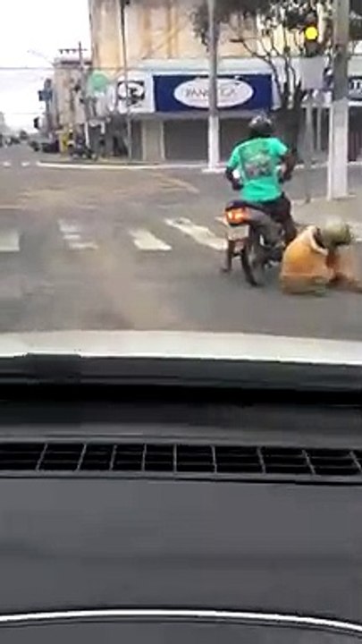 2 guys a little drunk and trying to get on the motorbike........