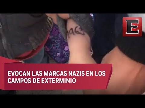 Autoridades migratorias marcan niños migrantes en los brazos