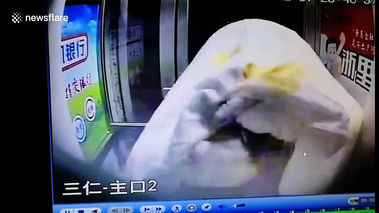 Alleged scammer scrambles out of ATM after being scared by staff's voice